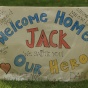 sign that says "Welcome home, Jack! Our Hero!". 