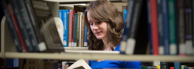 photo of U.B. student, Lauren, in library. 