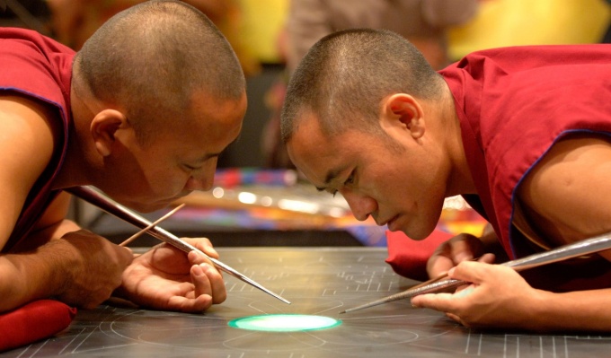 Buddhist monks creating a sand Mandala at during the Dalai Lama's visit to UB. 