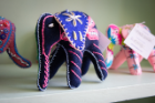 Hand-embroidered elephants — made by the refugee women and available for sale at the Stitch Buffalo storefront and on their etsy store — represent success, wisdom and companionship. Photographer: Meredith Forrest Kulwicki