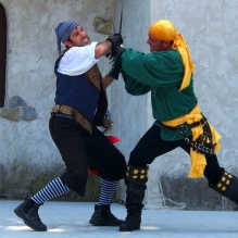 two men fighting a duel with swords. 