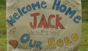 sign that says "Welcome home, Jack! Our Hero!". 