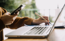 Hands dialing a phone. 