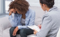 A mental health professional speaks to a client. 