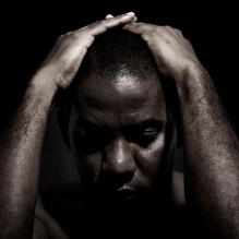 Black and white image - man with hands on head. 