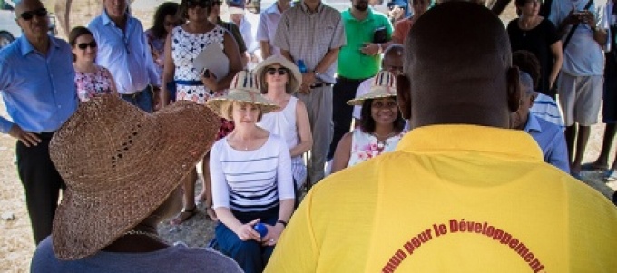 A group of people listening to a presentation in Haiti. 