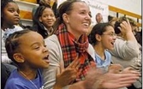 Woman and children cheering from bleachers. 