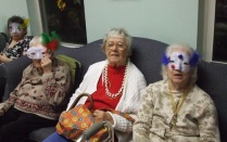 Elderly people wearing festive masks. 