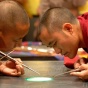 Buddhist monks creating a sand Mandala at during the Dalai Lama's visit to UB. 