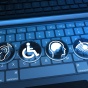 Keyboard with accessibility icons indicating hearing, vision and mobility access. 