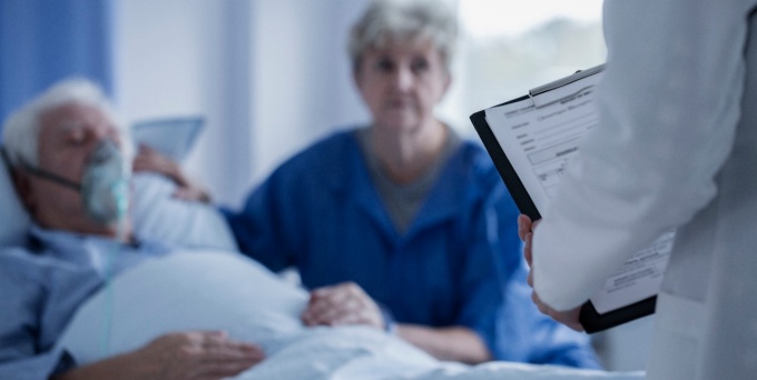 doctor and patient with spouse at hospital. 