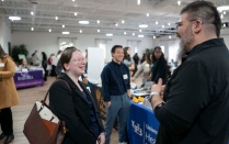 Zoom image: Students talking to agency staff at field fair. 