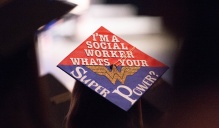 Zoom image: mortarboard saying "I'm a social worker, what's your super power?"