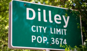 City sign stating Dilley, City Limit, Pop. 3674. 