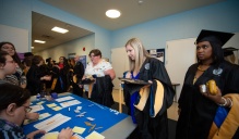 Zoom image: students checking into commencement. 