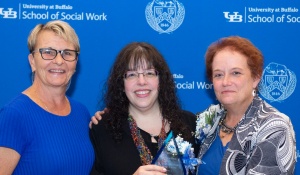 Susan Green, Molly Wolf, and Dean Nancy Smyth pose with award. 
