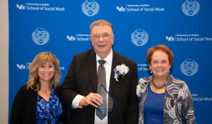 Edo G. Vander Kooy poses with colleagues with award at award ceremony. 