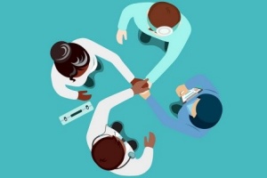 Illustrated group of four people holding one hand in center of a circle. 