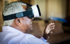 Elderly Black man wearing VR headset. 
