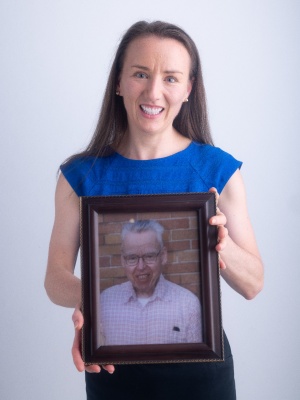 MSW student Kathleen Riley holds a picture of her late father Robert J. Riley, MSW ’68, BS ’55. 
