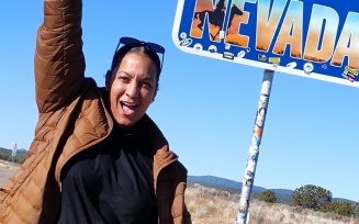 Zoom image: Franco at a Nevada state sign. 