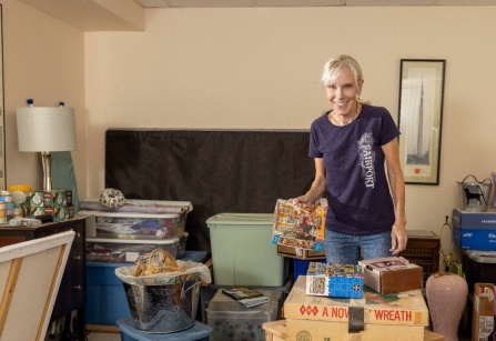 Zoom image: Cindy German in her house organizing items. 