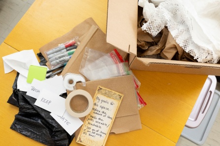 Zoom image: Decluttering organization prep, lists, tape, markers, boxes.