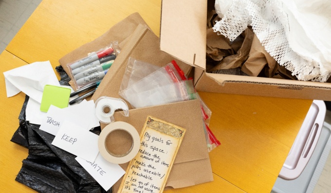 Decluttering organization prep, lists, tape, markers, boxes. 