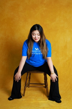 Tiffany Nhan in chair wide leg pose.