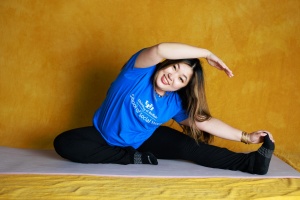 Tiffany Nhan in seated side stretch pose.