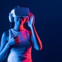 A woman uses a virtual reality headset. 