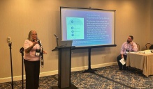 Tina Zerbian (left) presents with Andrew Studley, CEO of Connecting Communities in Action, (right) in Seattle Washington on August 28th. 