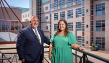 Niagara Falls City School District Superintedent Mark Laurrie and ITTIC's project manager and trainer, Megan Koury seen in front of Niagara Falls High School. 